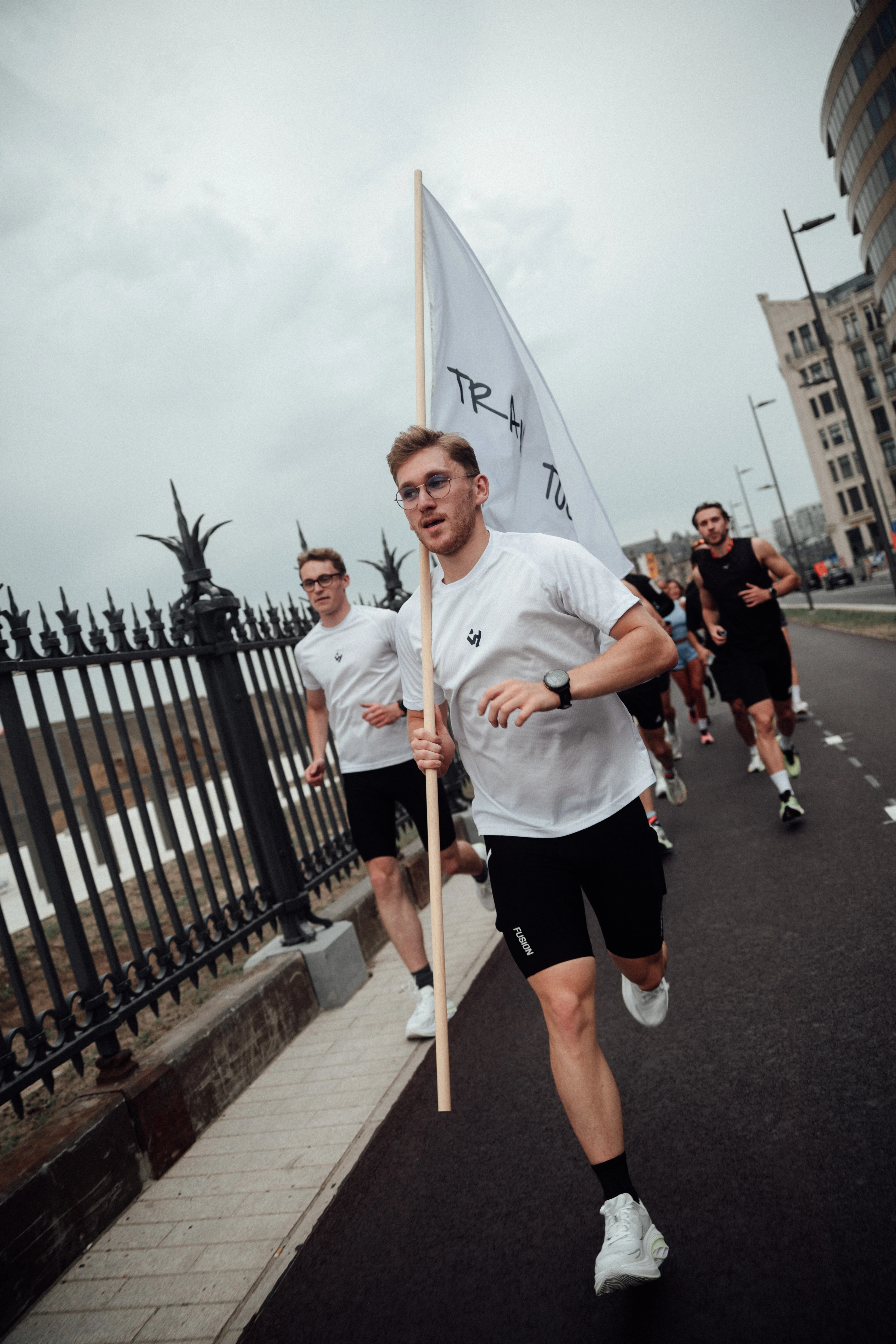 Wyder run club — runner carrying the Wyder flag